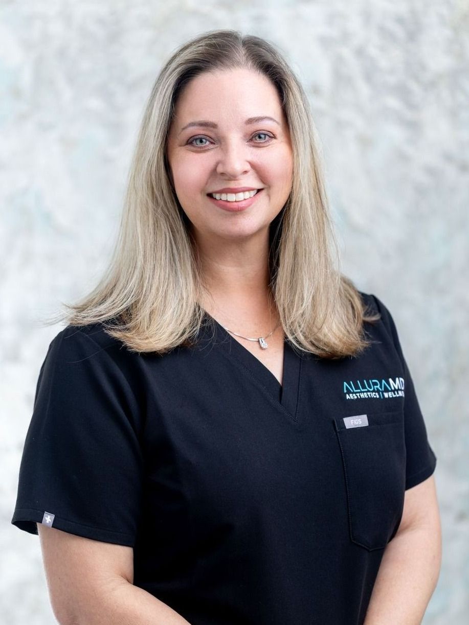 nurse practitioner kristi wittingham smiling in her scrubs