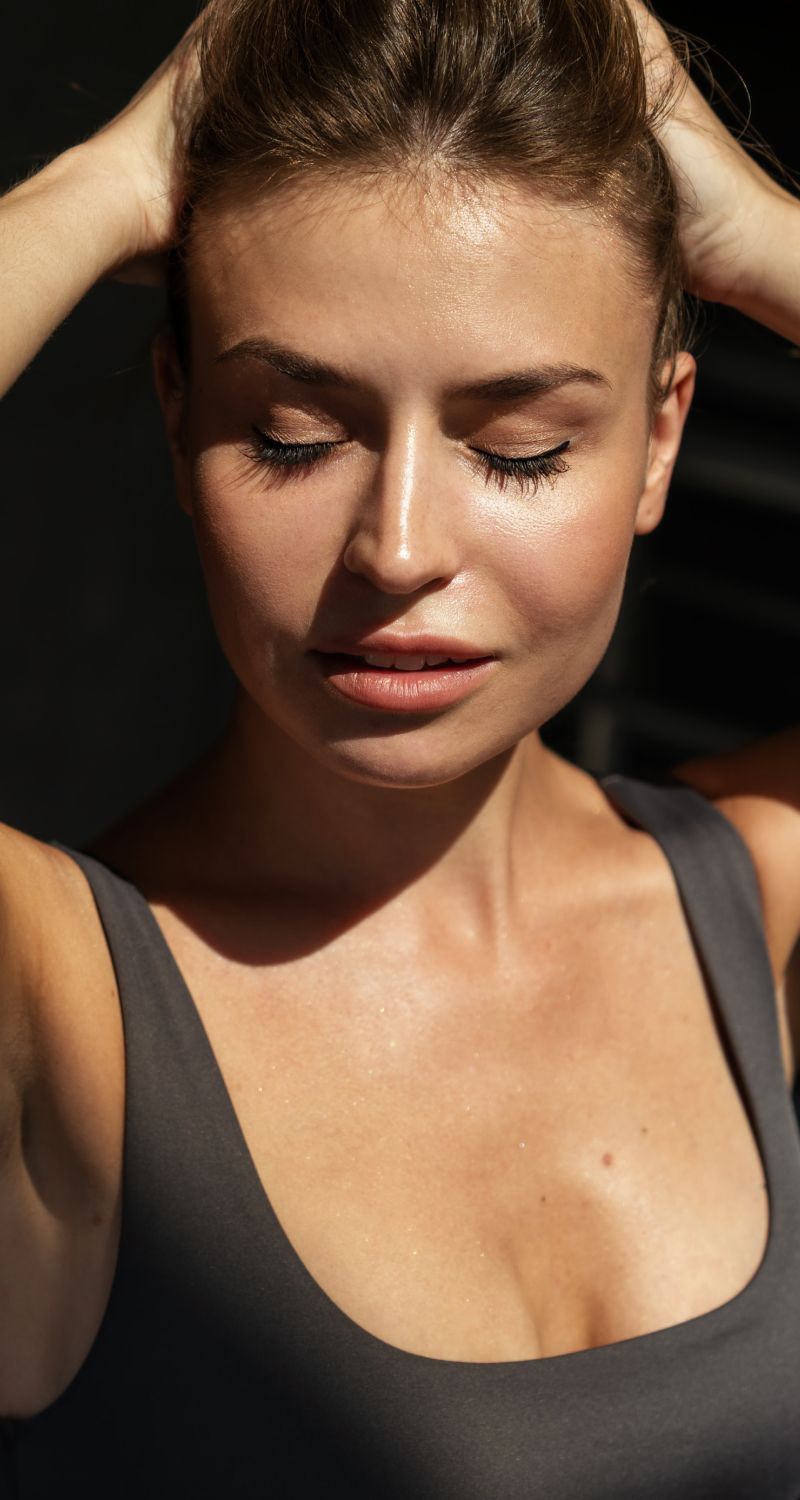 Woman with closed eyes in natural light.