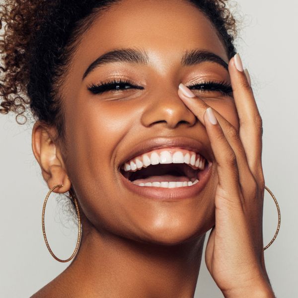 morpheus8 patient model laughing and touching her face