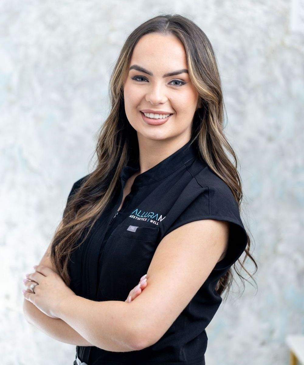 practice manager gabriela baszton in black attire with crossed arms.