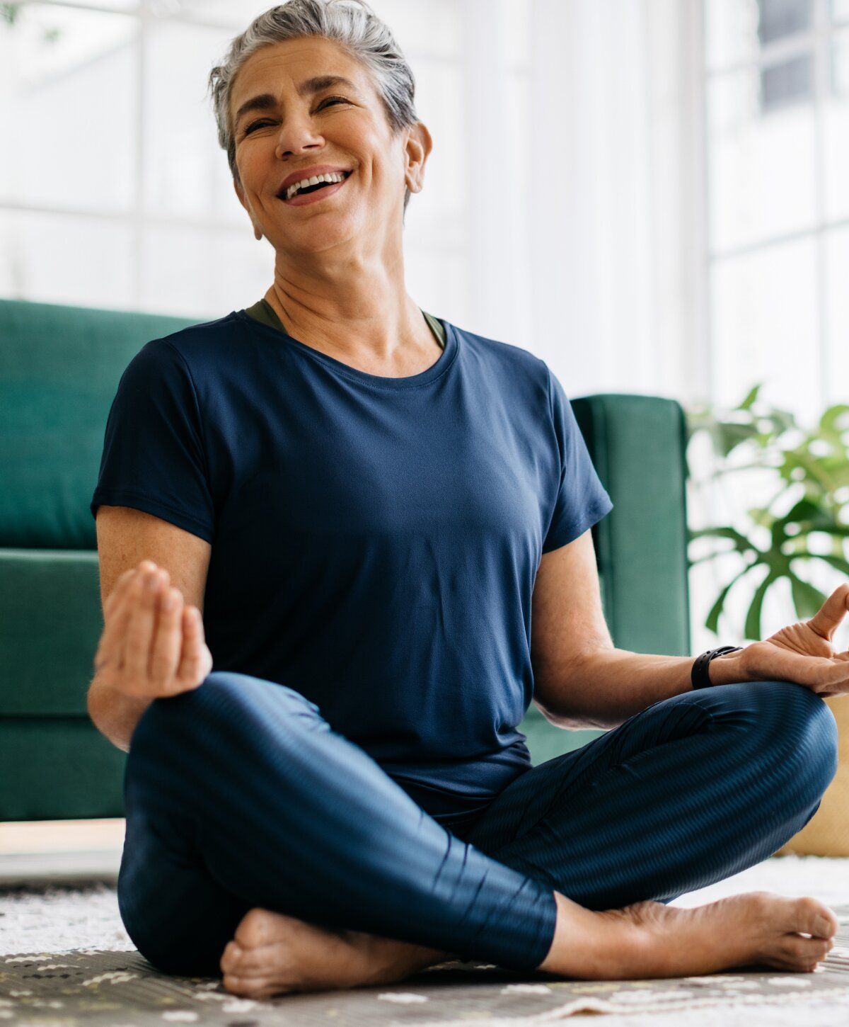 Smiling sermorelin patient model practicing meditation indoors.