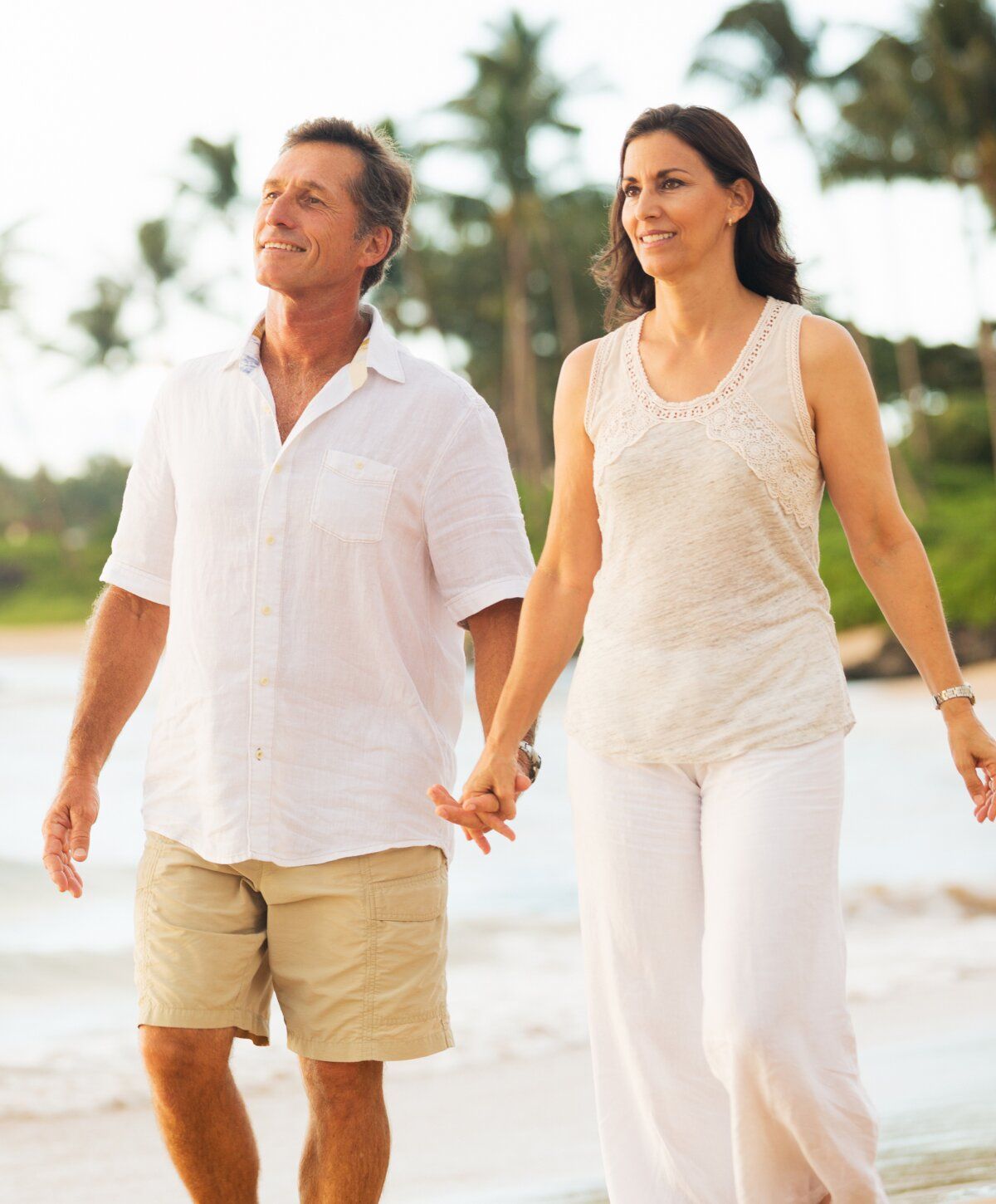 micronutrient testing patient couple walking hand-in-hand on the beach.