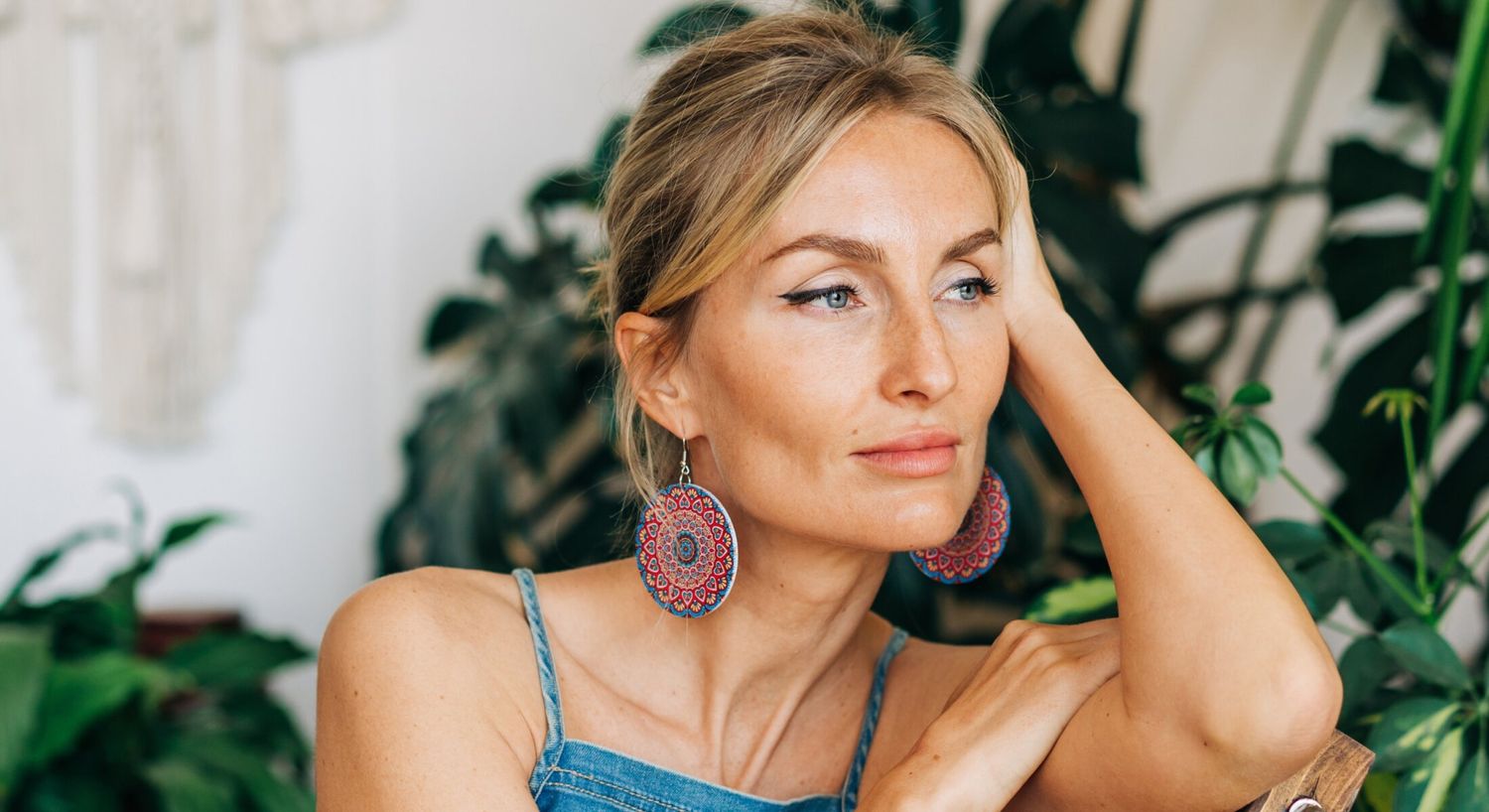 accutite patient model in a denip dress and mosaic earrings