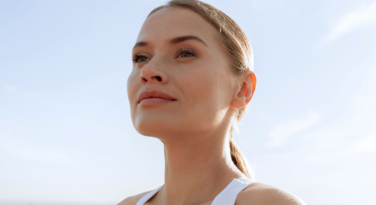 Belotero Balance patient model in a white top standing outside