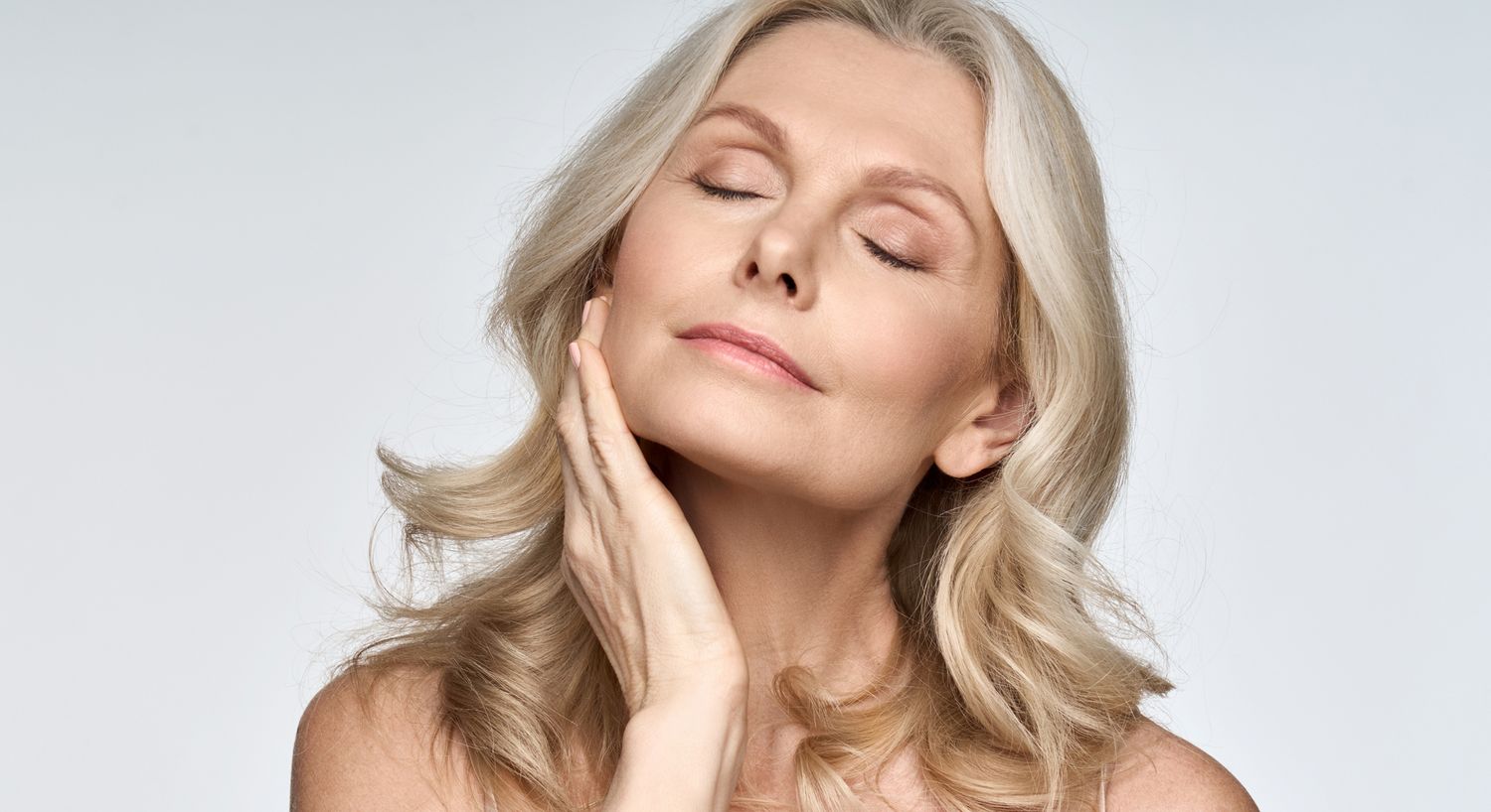 Evoke patient model touching her face with her eyes closed