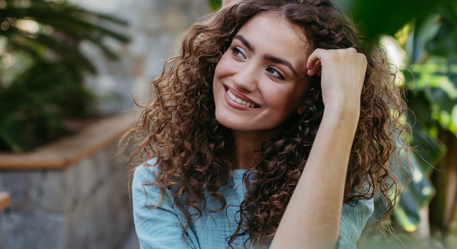 Semax peptide therapy patient model with curly red hair smiling broadly in a blue dress