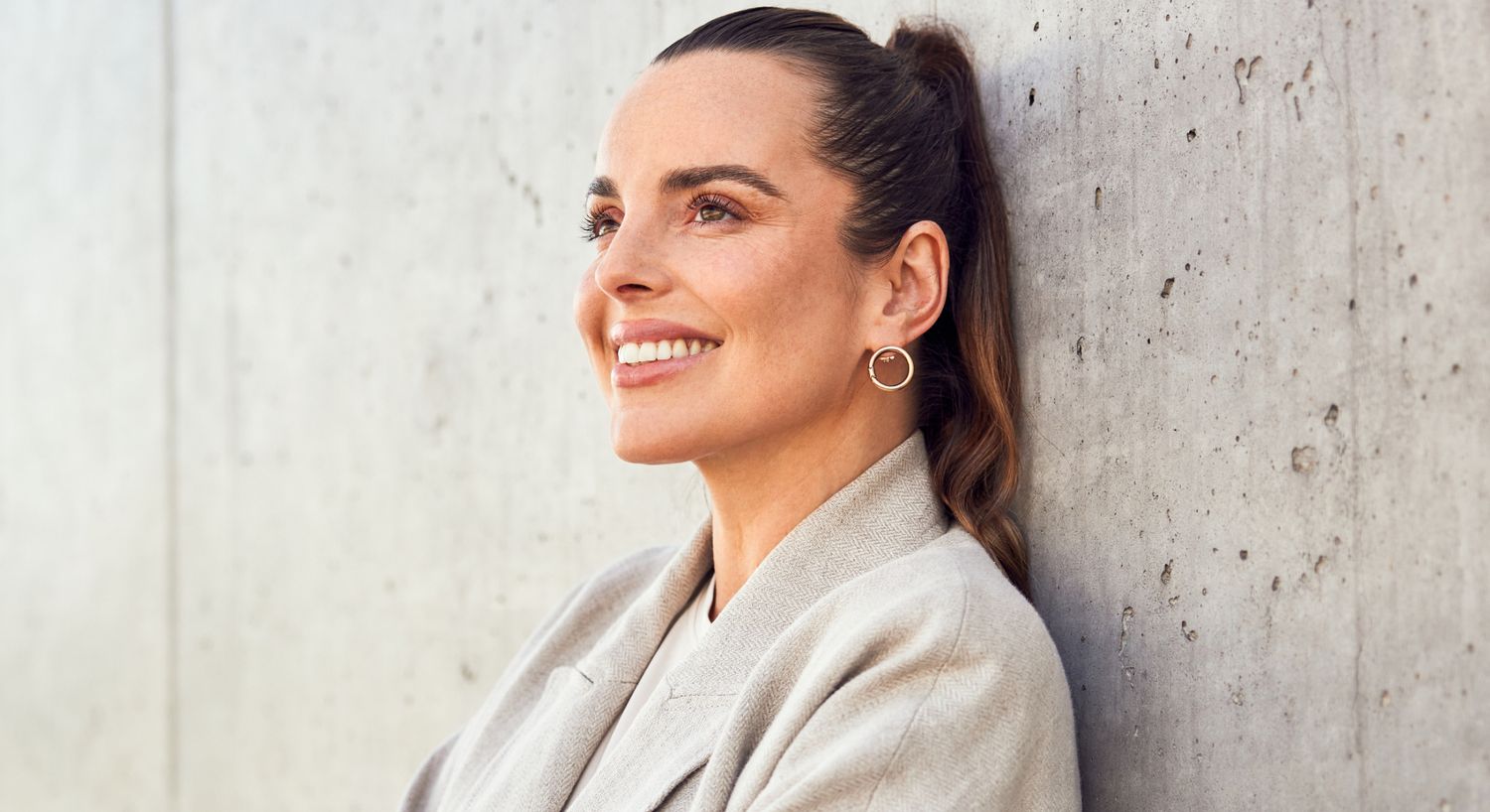 emface patient model smiling wearing hoop earrings
